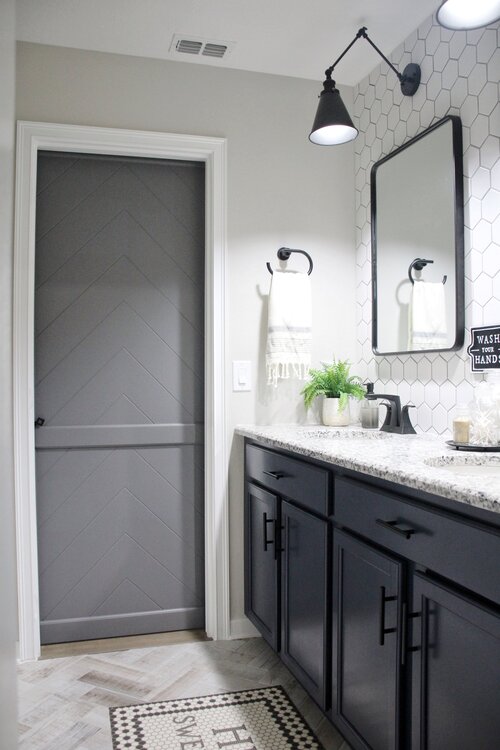 Renin Gatsby Barn Door Mix & Match View of grey bathroom barn door with a black lock from inside the bathroom.