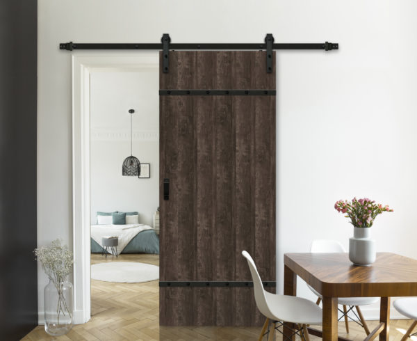 Flowers on wooden table in white flat interior with lamp above